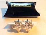 a pair of cufflinks that are sitting on a table