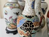 many vases that are sitting on a table