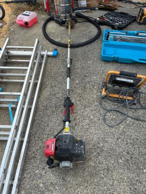 a picture of a corded pole sawing machine and other tools