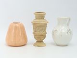 three vases sitting next to each other on a white surface