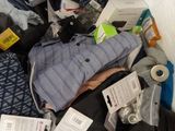 a pile of clothing and other items on a bed