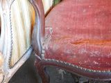 a red chair that is sitting in the corner of a room