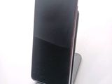 a cell phone that is sitting on top of a stand
