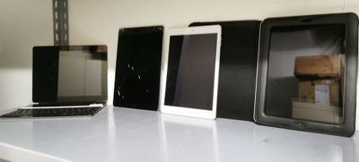 a lot of different types of cell phones on the table