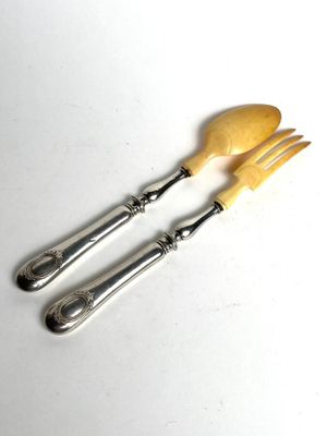 two forks and spoons are sitting on a white surface