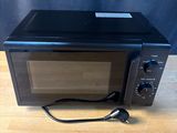 a microwave that is sitting on a wooden table