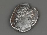 a close up of a silver coin with a woman on it