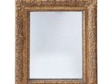a close up of a mirror on a white surface with a white background