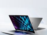 two laptops side by side on a white surface with a blue and purple background