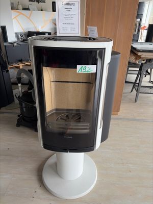 a black and white stove sitting on a pedestal in a room
