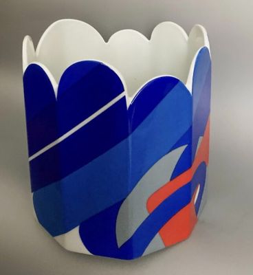 a vase that has a blue and red design on it