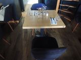 tables and chairs in a restaurant with blue walls and wood floors