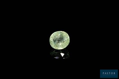 a close up of a green diamond on a black surface