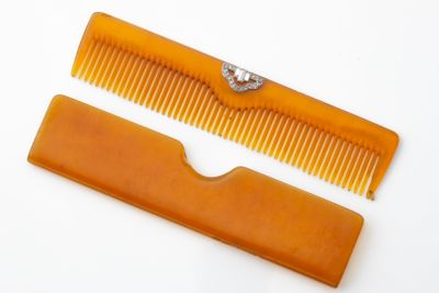 two combs that are sitting next to each other on a table