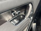 a close up of a car door handle with a cell phone in it