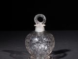an old glass bottle with a handle on a black surface