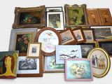 a lot of framed pictures and paintings on the wall
