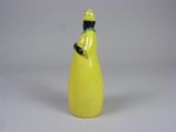 a yellow vase that has a woman in a hat on it