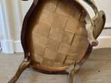 a wooden chair that is sitting on a carpeted floor