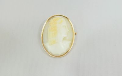a gold plated ring with a white stone in the center