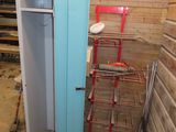 an image of a room with a blue door and a red chair