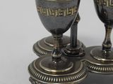 two silver cups sitting on top of each other on a table