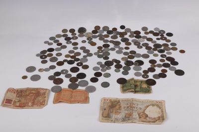 a lot of coins and a note sitting on a table