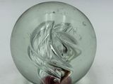 a glass ball with a horse in it on a table