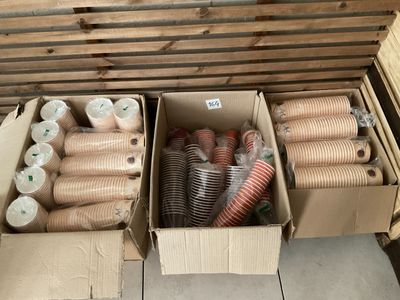 several boxes filled with different types of hoses sitting on top of a floor