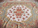 an image of a close up of a rug on a bed