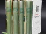 three books are stacked on top of each other on a table