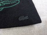 a close up of a black and green rug with a crocodile on it