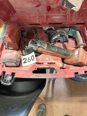 a red tool box with tools in it on the floor