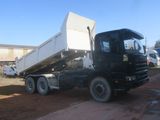 a black truck that is parked in the dirt