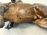 a bronze statue of a man sitting on a horse