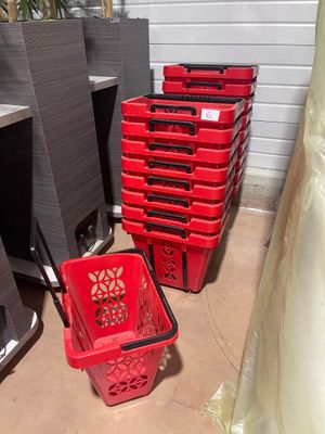 many red baskets sitting on the floor next to each other