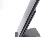 a cell phone on a stand on a white surface