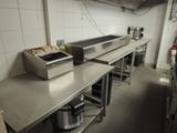 stainless steel counter top in a commercial kitchen with a toaster and toaster on it