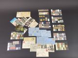 Plusieurs types de timbres et de cartes postales sont disposés sur une table