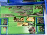 a blue box filled with assorted tools and a pair of scissors