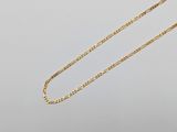 a close up of a gold chain on a white background