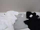 a pile of clothing on a table with a tag on it