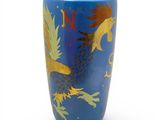 a blue vase with a gold dragon design on it