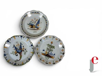 three plates with birds painted on them on a white surface