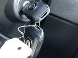 a car door handle with a key in it and a price tag attached to it