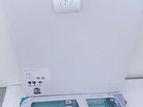 a white toilet with a paper dispenser next to it