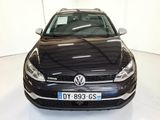 the front of a black vw golf parked in a white room