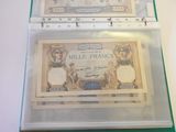 two bills in a clear box on a table