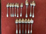 a lot of silver spoons and spoon spoons on a table