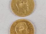 two pieces of gold coins with a man ' s face and a woman ' s head